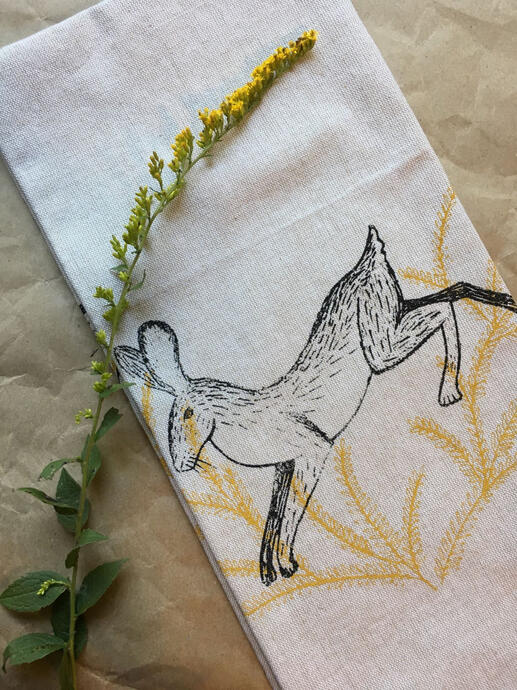 image of a screen printed tea towel featuring a rabbit